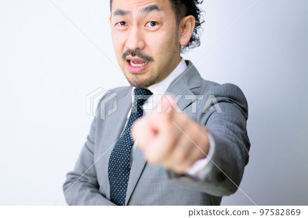 An office worker who gets angry by pointing at a white background that is easy to use An office worker who gets angry by pointing at a white background that is easy to use 97582869
