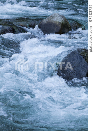 Melted snow water flowing in the river 97583725