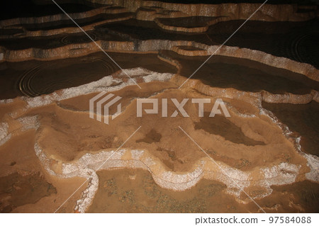 Scenery of a dark limestone cave 97584088