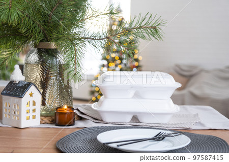 Food delivery service containers on table in white kitchen, festively served for celebration of Christmas and new year. Saving time, hot order, disposable plastic box, craft package. mock up Food delivery service containers on table in white kitchen, festively served for celebration of Christmas and new year. Saving time, hot order, disposable plastic box, craft package. mock up 97587415