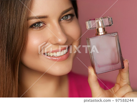 Perfume, beauty product and cosmetics model face portrait on pink background, beautiful woman holding fragrance bottle with floral feminine scent, fashion and makeup concept Perfume, beauty product and cosmetics model face portrait on pink background, beautiful woman holding fragrance bottle with floral feminine scent, fashion and makeup concept 97588244
