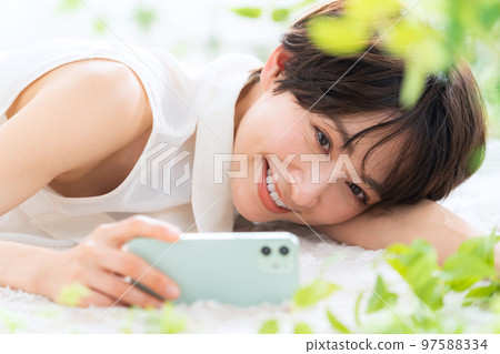 Woman beauty smartphone beauty skin care living room 97588334