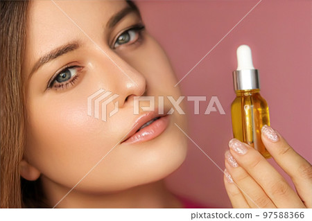 Beauty, makeup and skincare cosmetics model face portrait, woman holding skin care cosmetic essential oil bottle with dropper, luxury facial care product mockup 97588366