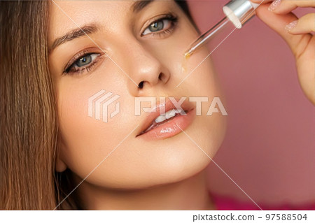 Beauty, makeup and skincare cosmetics model face portrait, woman applying skin care cosmetic product with dropper pipette, luxury facial care mockup 97588504