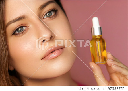 Beauty, makeup and skincare cosmetics model face portrait, woman holding skin care cosmetic essential oil bottle with dropper, luxury facial care product mockup 97588751