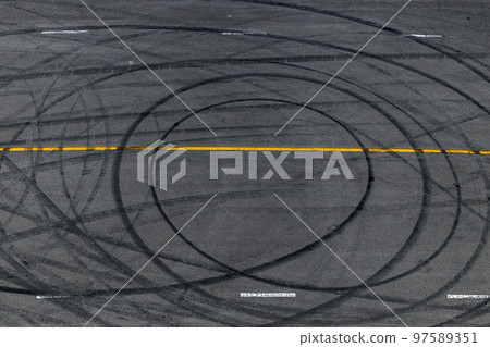 Tire track mark on asphalt tarmac road race track texture and background, Abstract background black tire tracks skid on asphalt road in racing circuit, Tire mark skid mark on asphalt road. 97589351