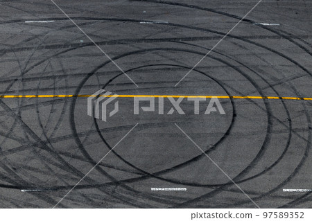 Tire track mark on asphalt tarmac road race track texture and background, Abstract background black tire tracks skid on asphalt road in racing circuit, Tire mark skid mark on asphalt road. 97589352