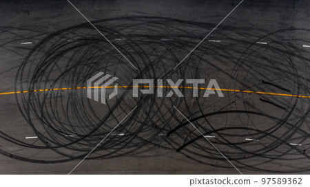 Top view tire tracks texture and background, Asphalt texture with line and tire marks, Automobile automotive tire skid mark on race track, Abstract texture car drift tire skid mark. 97589362