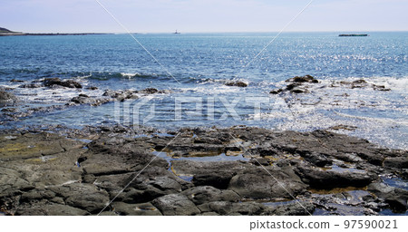 Stone rock sea beach with sunny sky 97590021