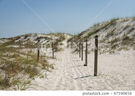 Pathway with wooden posts barrier from sand dunes at Destin, Florida 97590656