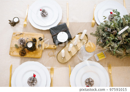 Beautiful table setting with Christmas tree decorations in the living room. Top view 97591015
