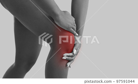 Woman who suffers from arthritis is feeling pain and touching her knee, banner background Woman who suffers from arthritis is feeling pain and touching her knee, banner background 97591044