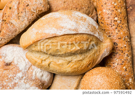 Homemade natural breads. Different kinds of fresh bread as background, top view with copy space Homemade natural breads. Different kinds of fresh bread as background, top view with copy space 97591492