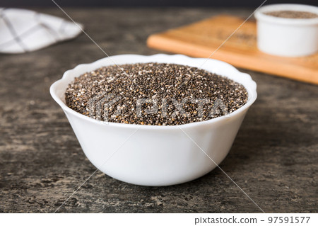 Chia seeds in bowl on colored background. Healthy Salvia hispanica in small bowl. Healthy superfood 97591577