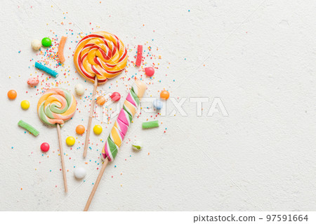 Tasty appetizing Party Accessories Happy Birthday Sweet. Different types of candies on colored background, copy space. Colorful birthday party background 97591664