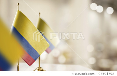 Small flags of the Colombia on an abstract blurry background 97591798