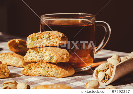 Biscotti Cantuccini Cookie Biscuits with pistachios and lemon peel Shortbread. Cup of tea. Teatime break Healthy eating food. Homemade fresh Italian cookies cantucci stacks and organic pistachios 97592257