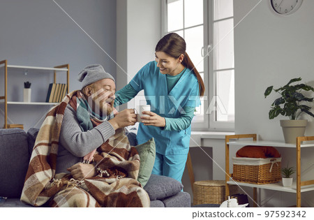 Caregiver giving cup of tea to a frozen senior man. Nursing home service and patient support. Caregiver giving cup of tea to a frozen senior man. Nursing home service and patient support. 97592342