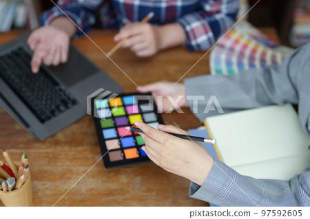 A group of professional web developer and graphic designer working together in the office. A group of professional web developer and graphic designer working together in the office. 97592605