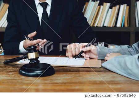 Discussing legal matters and signing important documents. 97592640