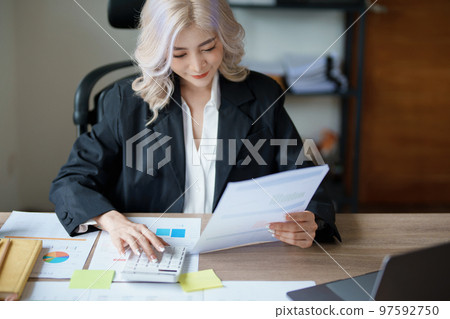 Accountants, Asian auditors are using calculators and computers to review annual tax budgets to submit information to the IRS Accountants, Asian auditors are using calculators and computers to review annual tax budgets to submit information to the IRS 97592750
