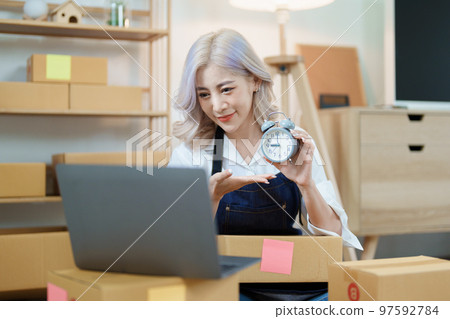 Starting small business entrepreneur of independent Asian woman smiling using computer laptop with cheerful success of online marketing package box items and SME delivery concept. Starting small business entrepreneur of independent Asian woman smiling using computer laptop with cheerful success of online marketing package box items and SME delivery concept. 97592784