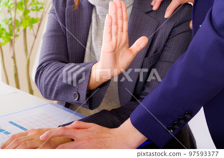 A woman showing a refusal intention with her palm 97593377