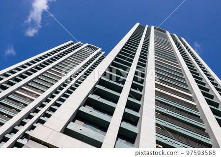 Low angle of apartment building over blue sky Low angle of apartment building over blue sky 97593568