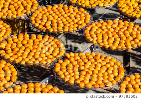 Dry Persimmon fruit production under sunshine in factory 97593602