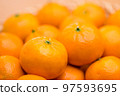 Stack of citrus fruit on basket 97593695