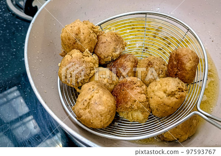 An Indian Street Food Group of Frying Pakora or Bhajiya in oil 97593767
