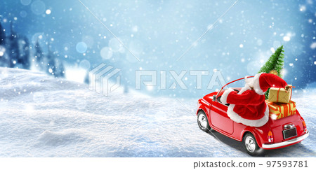 Santa Claus in Red car delivering christmas tree and presents at snowy background. Christmas card 97593781