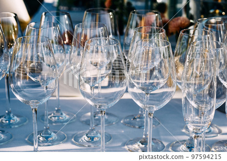 A set of glasses for wine before serving on the festive table A set of glasses for wine before serving on the festive table 97594215
