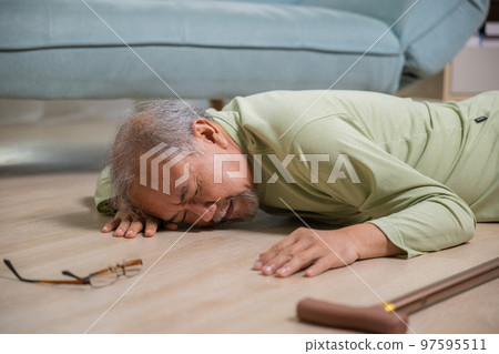 Asian elderly man retired headache after fall down, Sick senior old man falling down lying on floor at house alone with wooden cane walking stick in living room, Health care and medicine concept 97595511