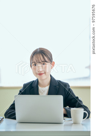 Young woman typing on a computer Young woman typing on a computer 97595676
