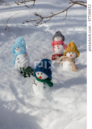 Snowmen playing sledding 97596652