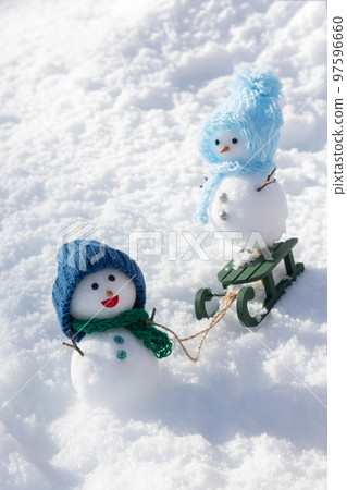 Snowmen playing sledding 97596660