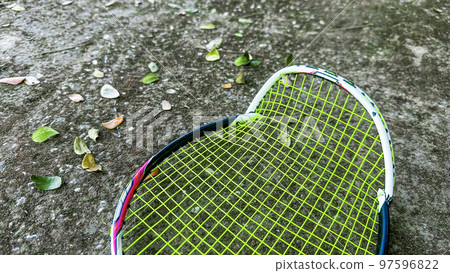 Close up broken badminton racket on dark background Close up broken badminton racket on dark background 97596822