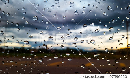Rain water drops cover on the glass with blur background Rain water drops cover on the glass with blur background 97596920