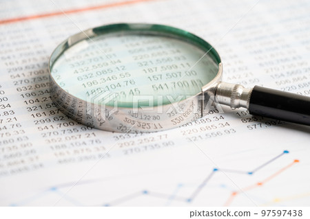 Magnifying glass on charts graphs paper. Financial development, Banking Account, Statistics, Investment Analytic research data economy, Stock exchange trading, Business office concept. Magnifying glass on charts graphs paper. Financial development, Banking Account, Statistics, Investment Analytic research data economy, Stock exchange trading, Business office concept. 97597438