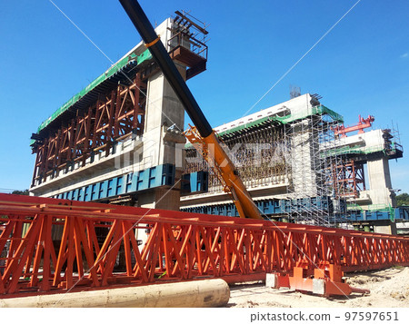 SELANGOR, MALAYSIA -JULY 6, 2022: An elevated road is under construction. Reinforced concrete is used for the structure. Construction is done in stages according to the sequence of works. SELANGOR, MALAYSIA -JULY 6, 2022: An elevated road is under construction. Reinforced concrete is used for the structure. Construction is done in stages according to the sequence of works. 97597651