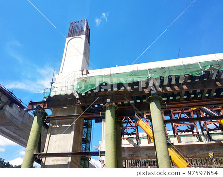 SELANGOR, MALAYSIA -JULY 6, 2022: An elevated road is under construction. Reinforced concrete is used for the structure. Construction is done in stages according to the sequence of works. SELANGOR, MALAYSIA -JULY 6, 2022: An elevated road is under construction. Reinforced concrete is used for the structure. Construction is done in stages according to the sequence of works. 97597654