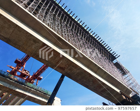SELANGOR, MALAYSIA -JULY 6, 2022: An elevated road is under construction. Reinforced concrete is used for the structure. Construction is done in stages according to the sequence of works. SELANGOR, MALAYSIA -JULY 6, 2022: An elevated road is under construction. Reinforced concrete is used for the structure. Construction is done in stages according to the sequence of works. 97597657