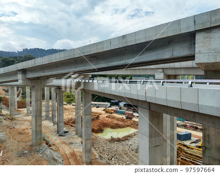 SELANGOR, MALAYSIA -JULY 6, 2022: An elevated road is under construction. Reinforced concrete is used for the structure. Construction is done in stages according to the sequence of works. SELANGOR, MALAYSIA -JULY 6, 2022: An elevated road is under construction. Reinforced concrete is used for the structure. Construction is done in stages according to the sequence of works. 97597664