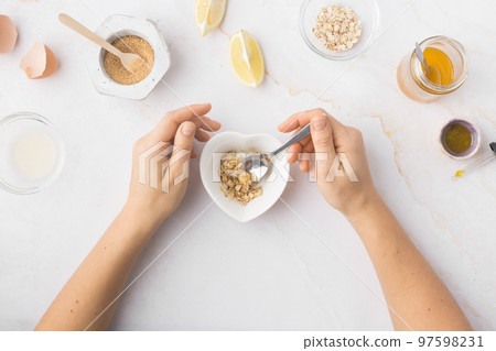 Flatlay with homemade beauty products: fresh ingredients like oat, honey, lemon, banana, egg, olive 97598231