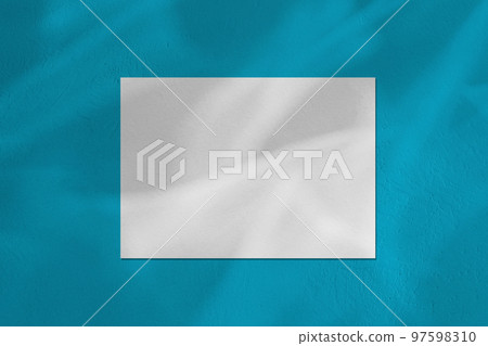 Empty white horizontal rectangle poster mockup on blue background Empty white horizontal rectangle poster mockup on blue background 97598310