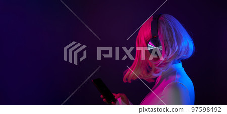 Woman in headphones listening music and enjoing Woman in headphones listening music and enjoing 97598492