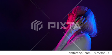Woman in headphones listening music and enjoing Woman in headphones listening music and enjoing 97598493