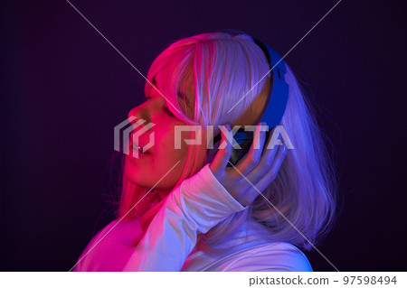 Woman in headphones listening music and enjoing 97598494