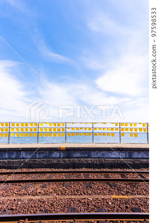 A yellow train with a beautiful sea in the background "Daisami-Higashi Station" A tourist attraction famous for yellow handkerchiefs and commercial filming locations: Shimabara City, Nagasaki Prefecture 97598533